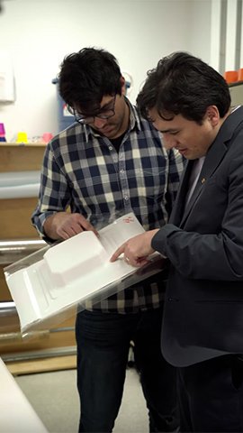 Professor Carlos Diaz Acosta looking at packaging.