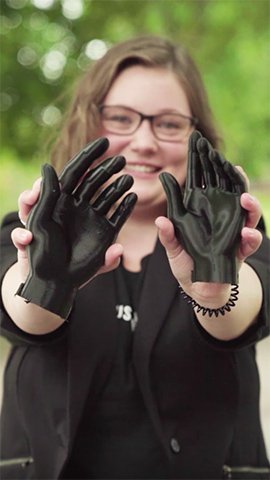 Landyn Hatch holding 3D printed hands.