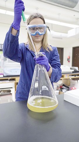 Nicole Pannullo working in a chemistry lab.