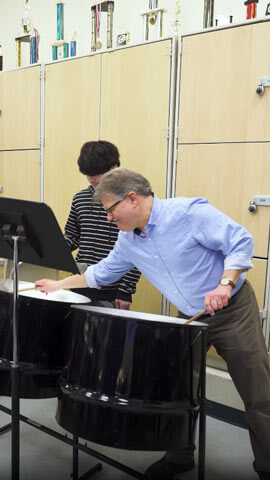 Ted Canning playing the steel drums during a Steelband Ensemble practice session.