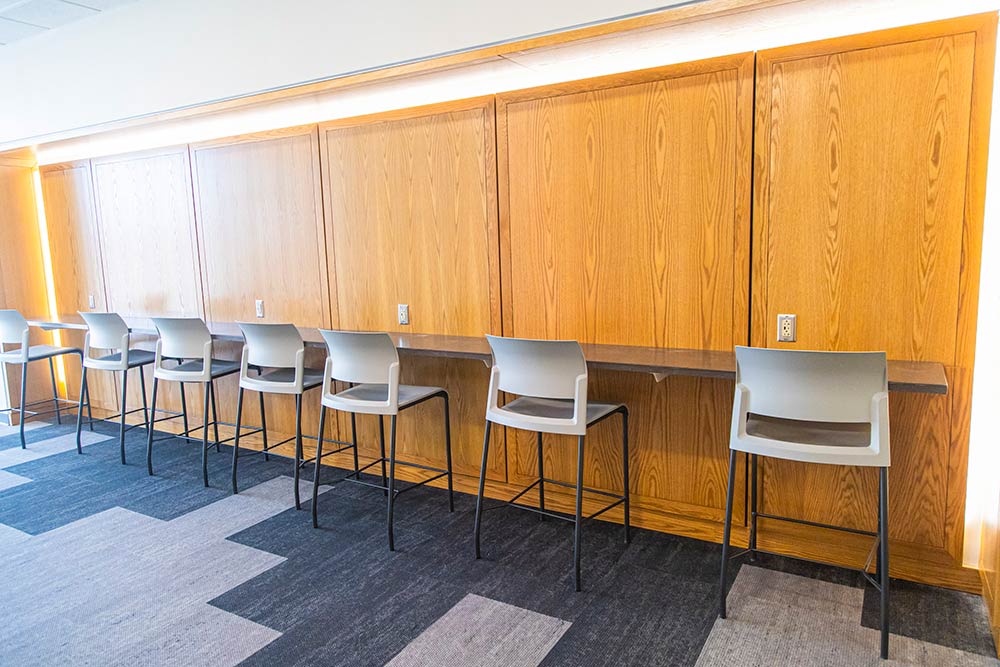 seven chairs lined up against a ledge.