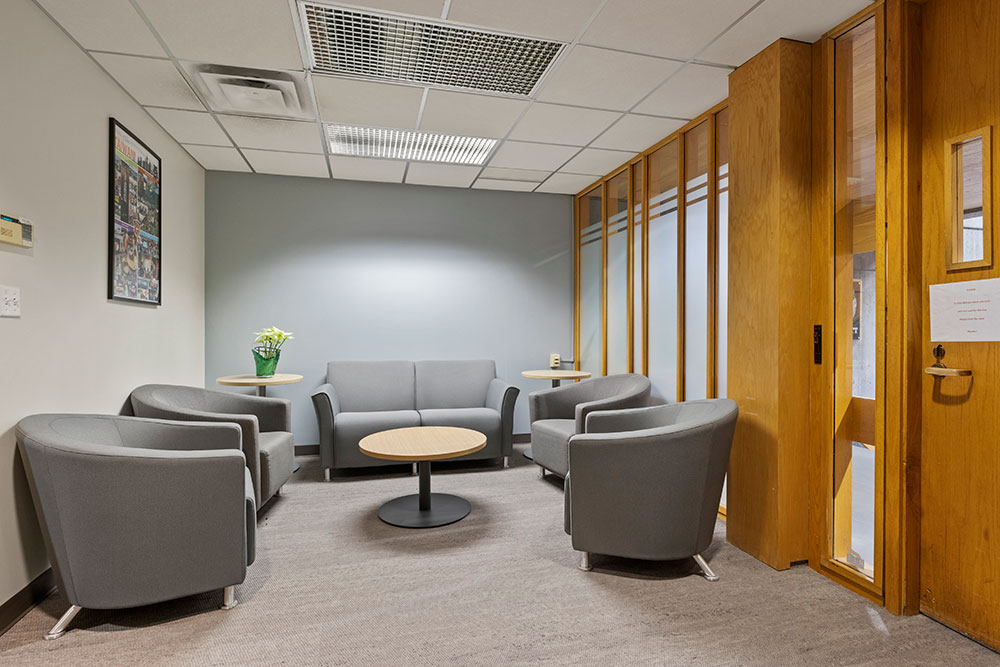 a reception area with soft seating and a small round coffee table.