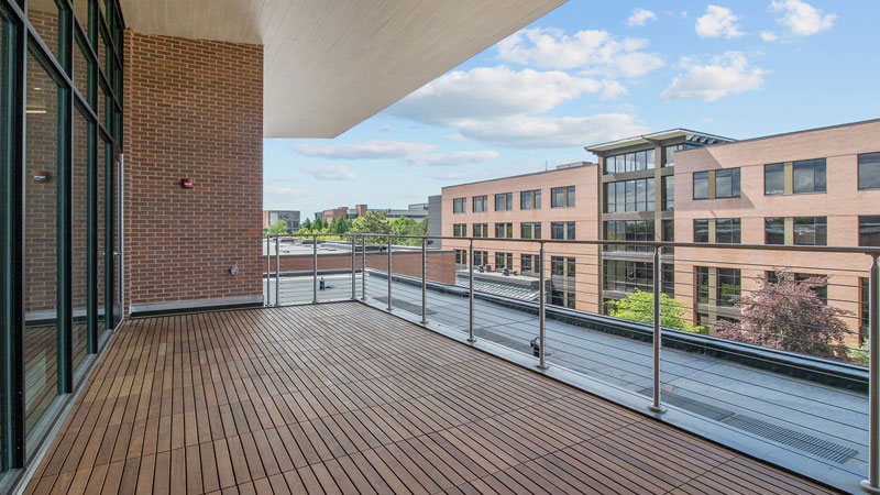 right side view of a terrace space with a wooden floor and railings.