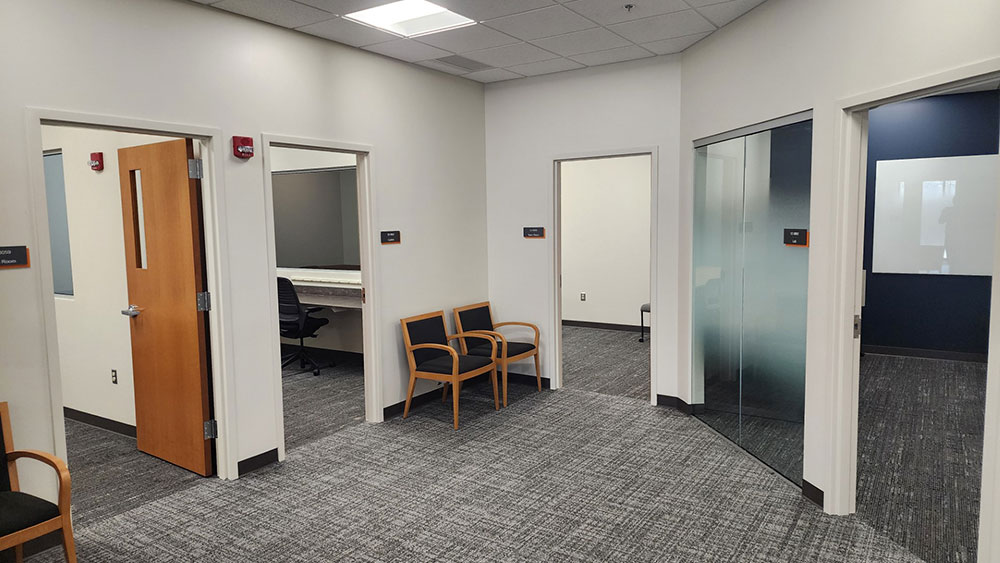 a reception area with several doors leading to other office spaces.