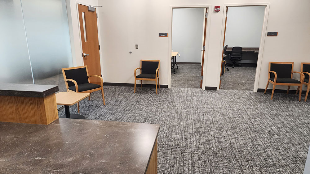 a reception area with seating and doors to other offices.