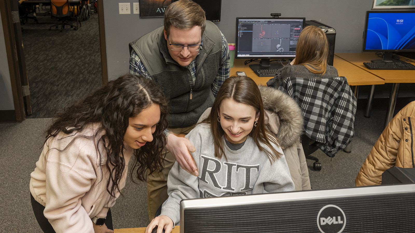Alan Gasek instructs students while they work on a computer.
