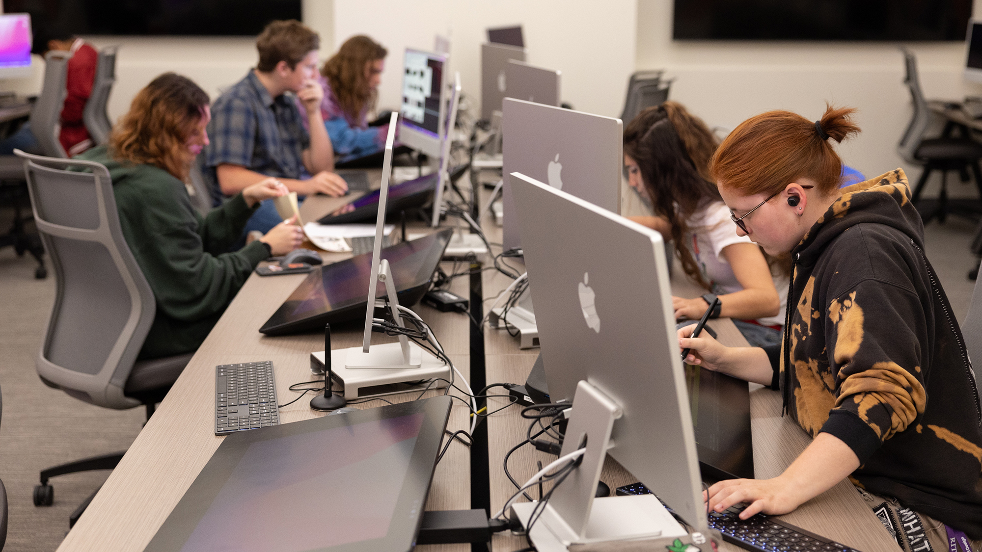 Students work at computer stations.
