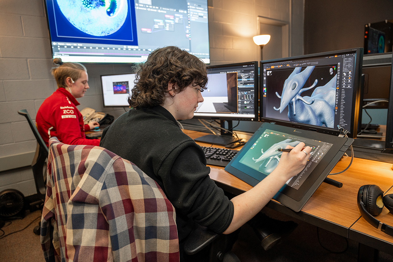 A student draws on a tablet.