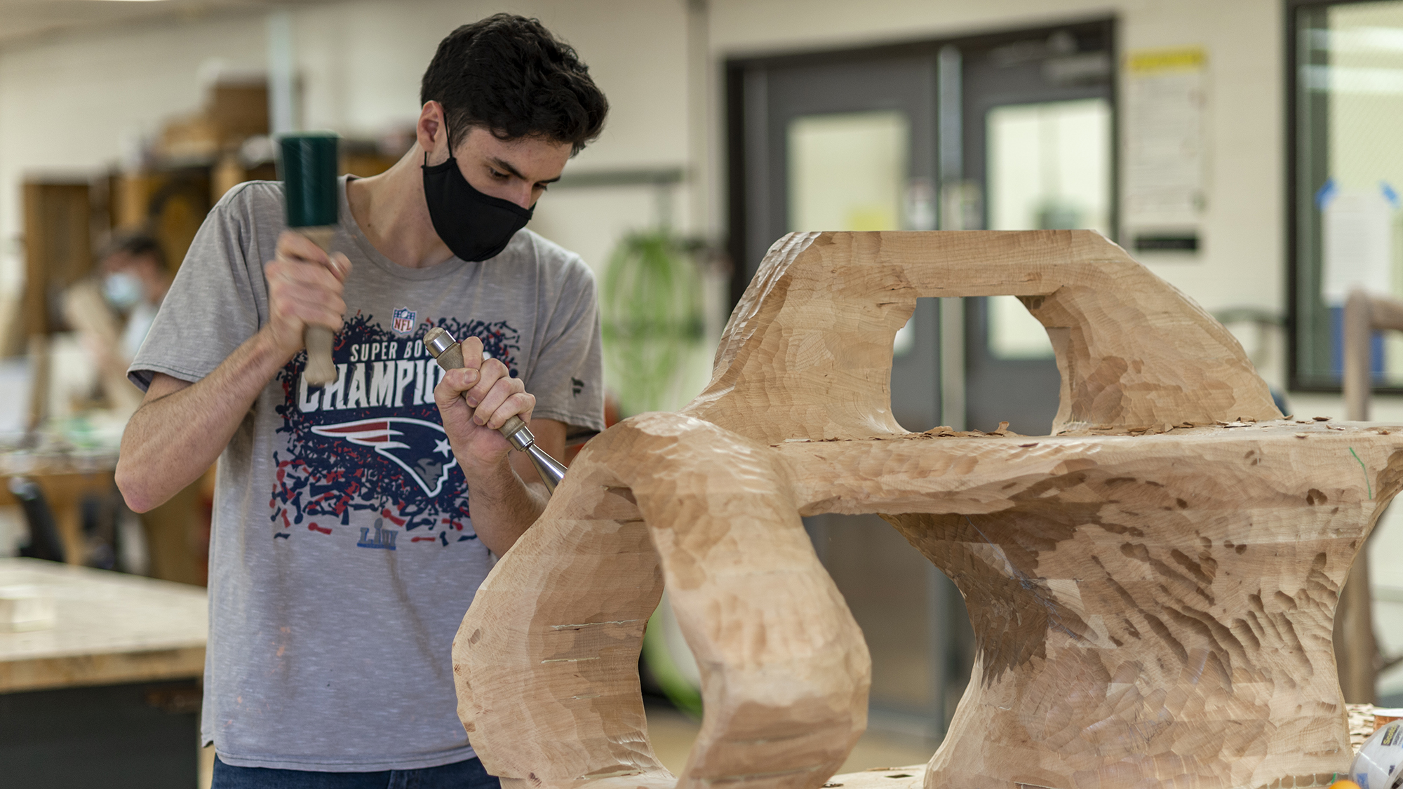 Furniture design student Jared Abner '21 works on a chair project in the bench room.