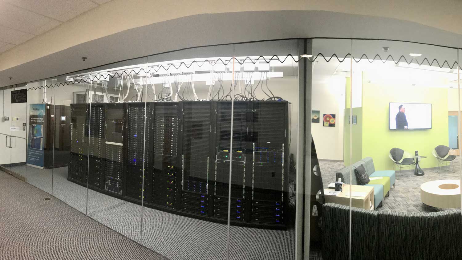 Glass walled room looking at server racks