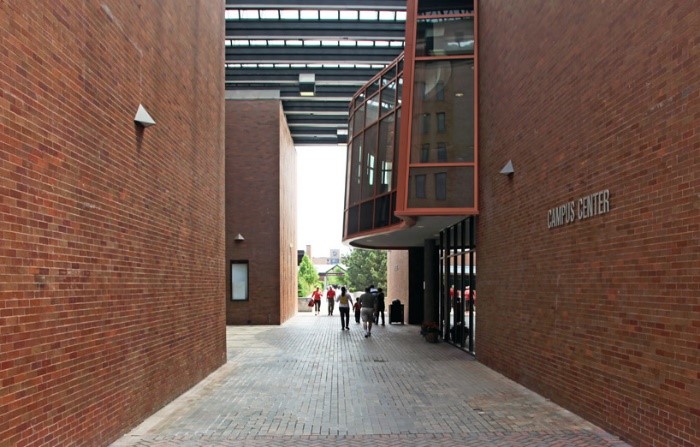 bricked pathway between two brick buildings.