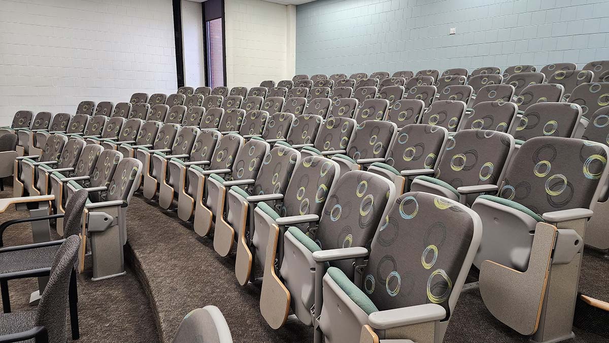 several rows of empty auditorium seating.