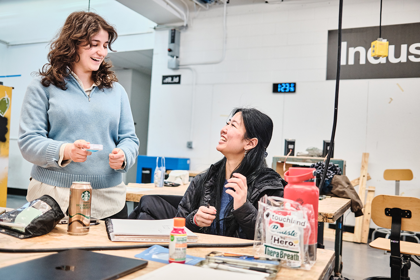 Two smiling students in the industrial design studio.