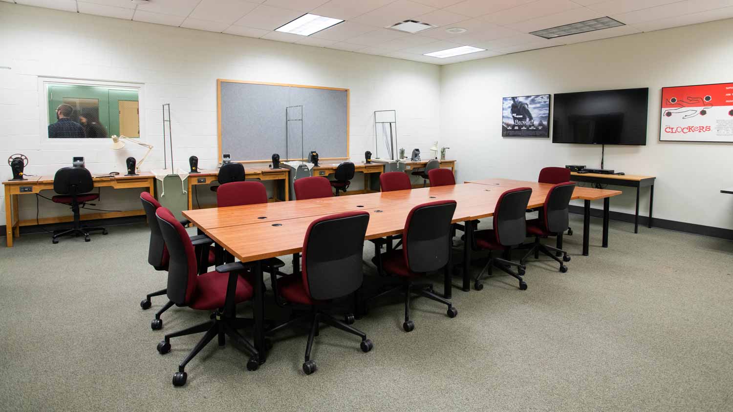 Seminar room with a large conference table facing a large TV screen