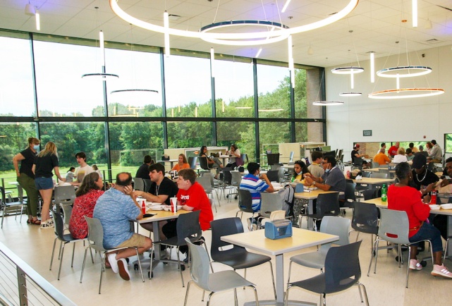 students sitting in Gracie's dining room, eating together.