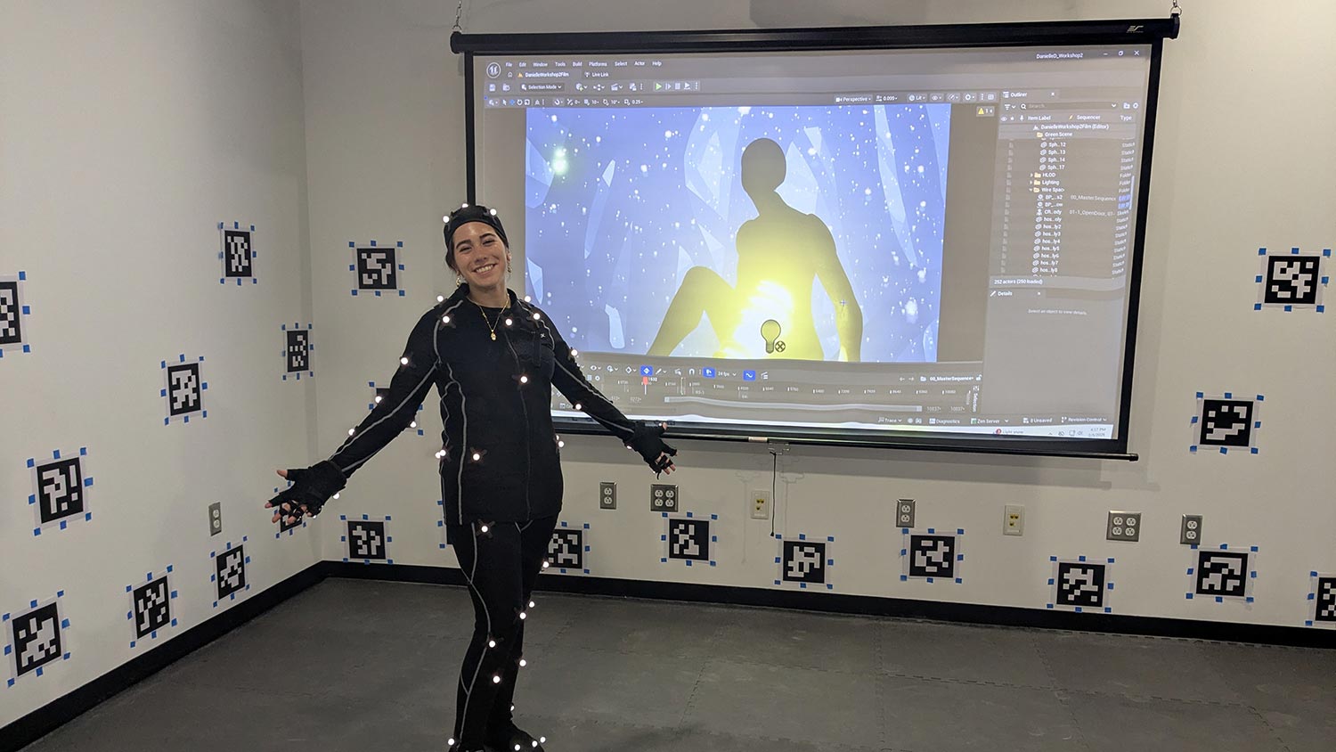 student wearing a suit with sensors in a room that captures movements.