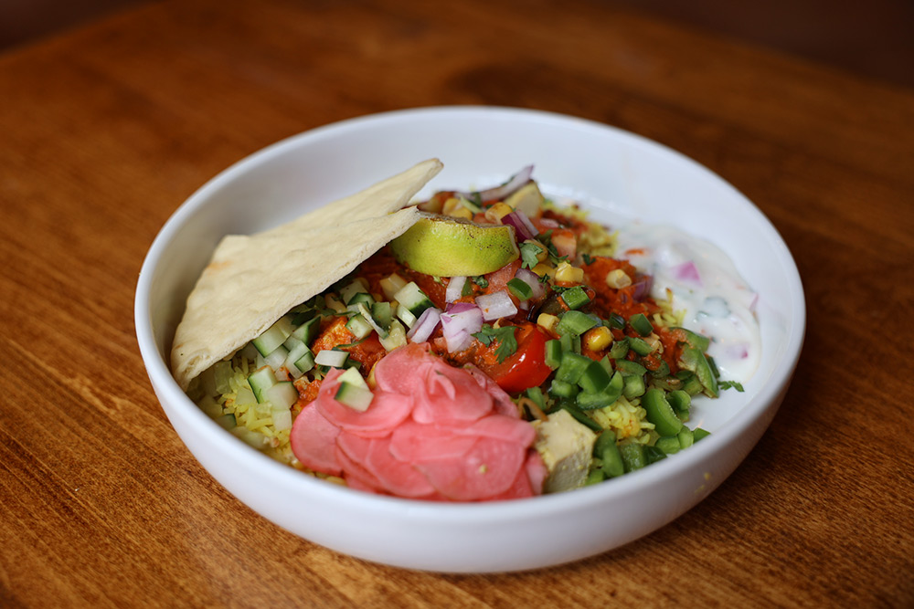 Build your own Indian bowl of rice, colorful veggies, and pita bread.