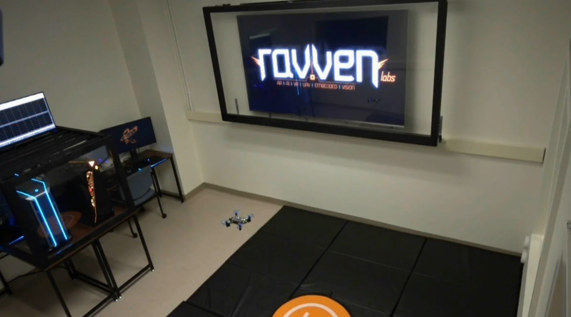 a lab with a large screen and a small drone flying.