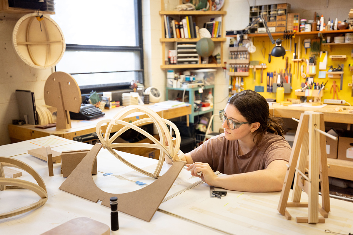 RIT furniture design's Hannah Giancola works in the program's graduate studio space, using hand tools.