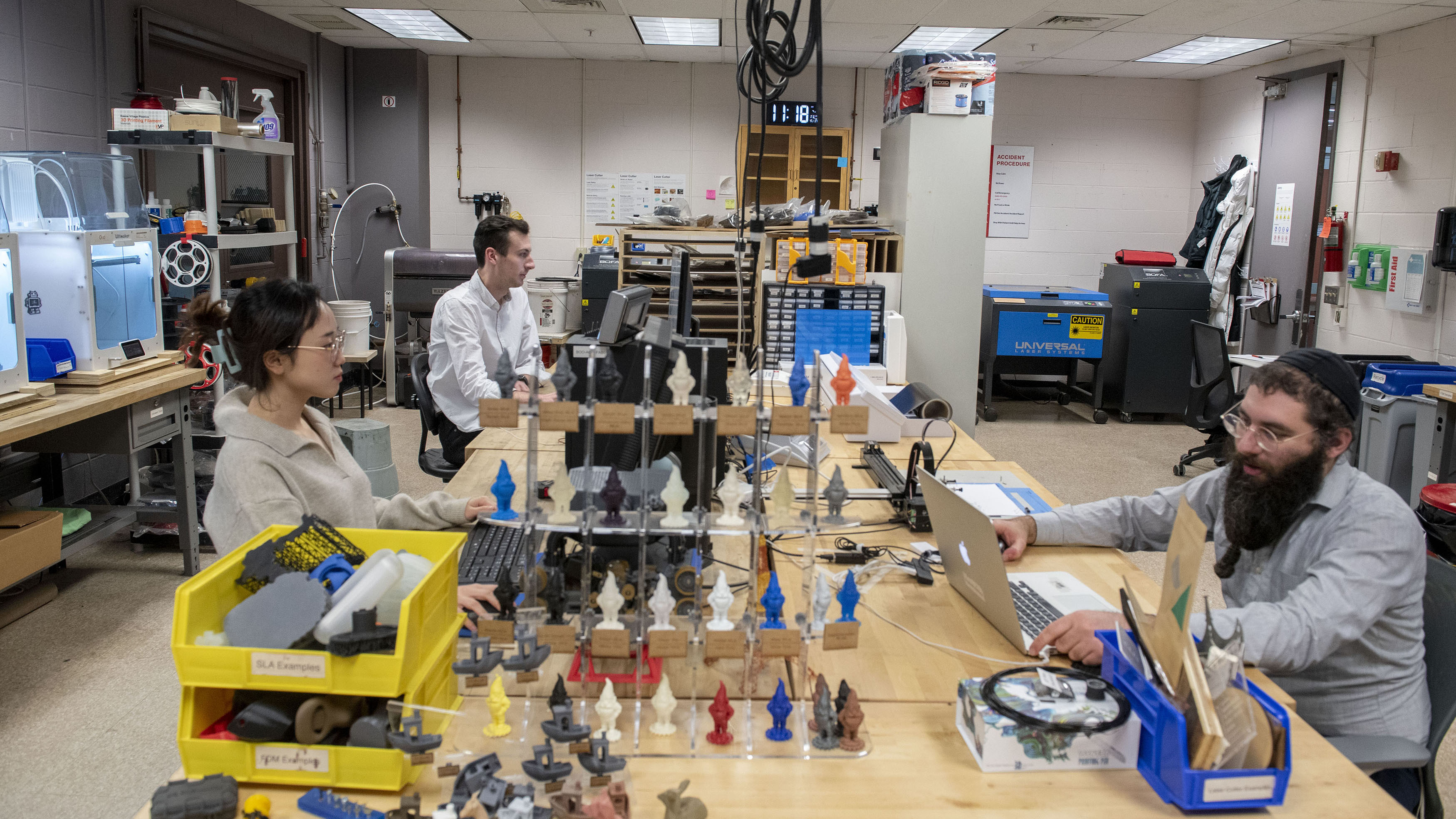 Dan Gabber and industrial design students Ari Lee and Matt Hotaling work in the Fab Lab.
