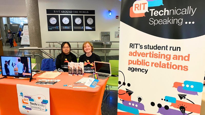 two students at a table during imagine RIT representing Technically Speaking