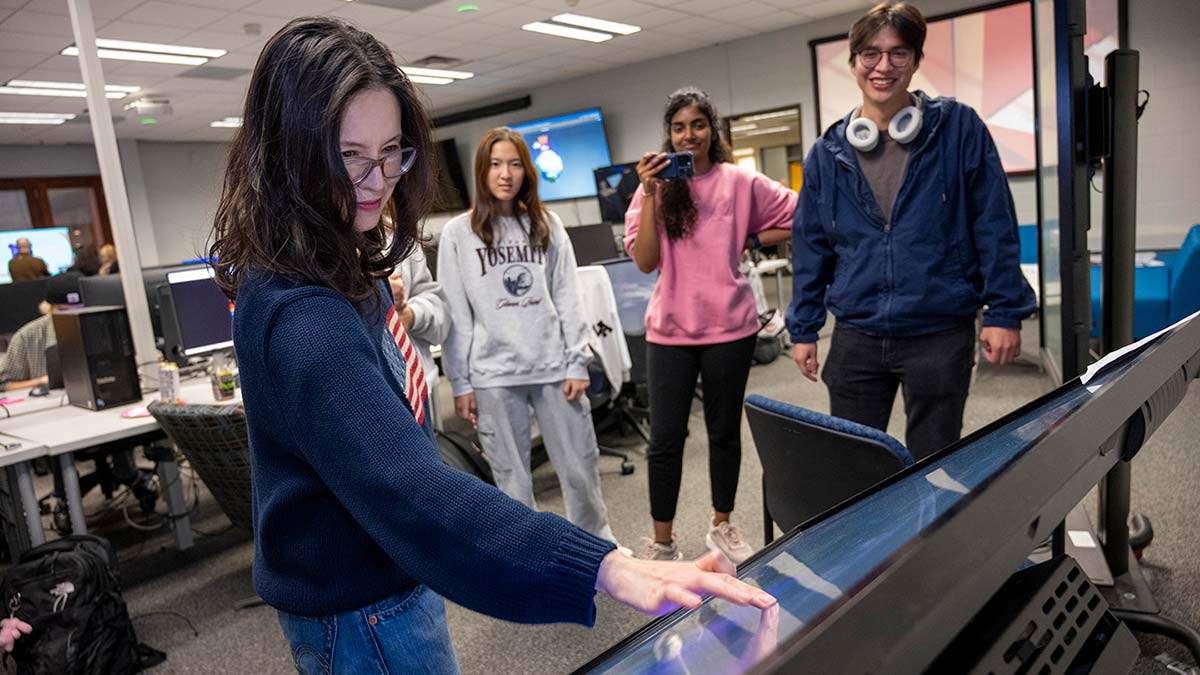 Faculty Hye-Jin Nae uses a large touchscreen, for a student project.