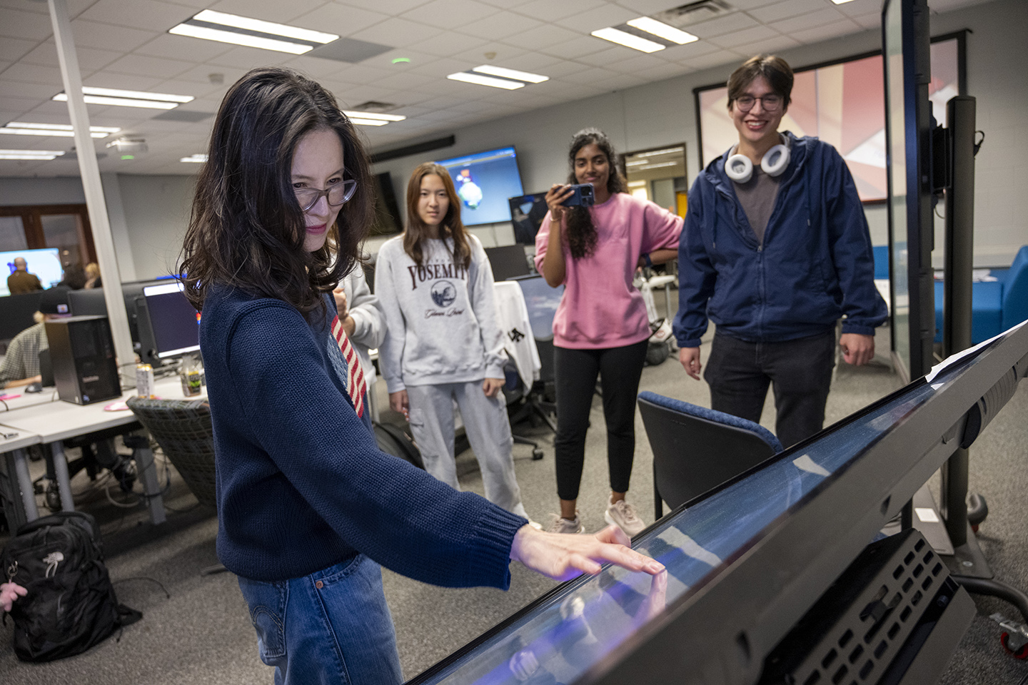 Faculty Hye-Jin Nae uses a large touchscreen, for a student project.