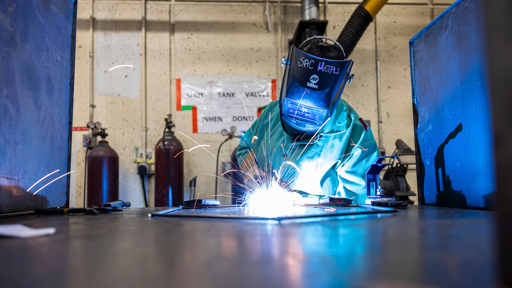 a student wears protective gear while welding.