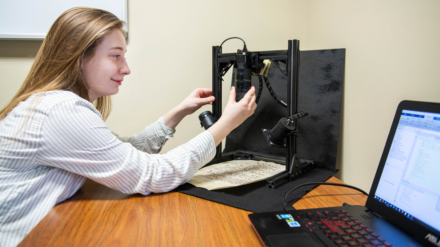 female student using imaging equipment to capture document