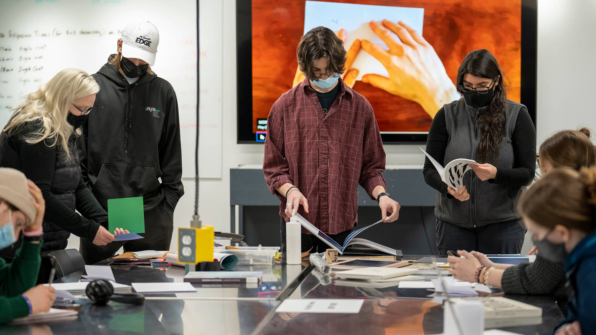 students looking through photo books.