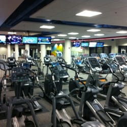 Interior of the fitness center showing multiple stationary bikes and treadmills.