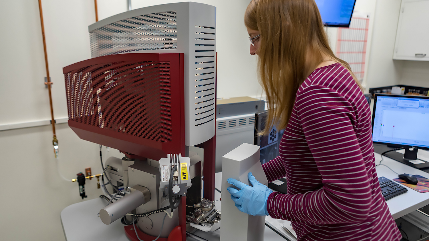 Female student working with equipment in imaging lab