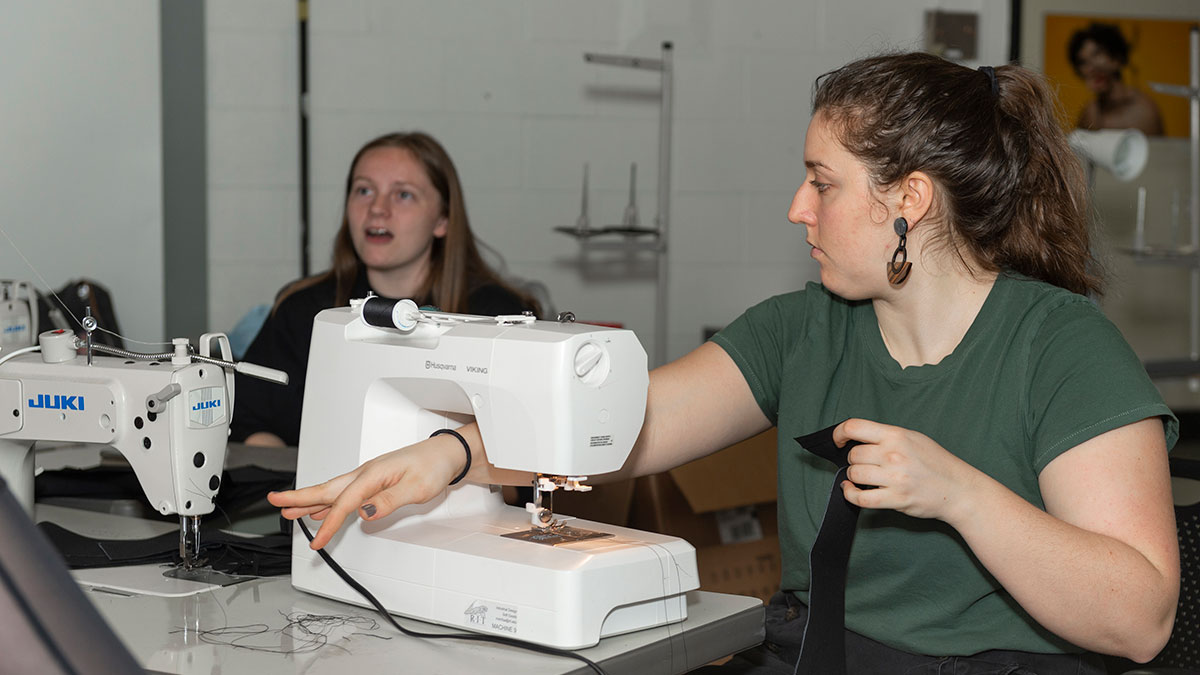 A student works on a sewing machine.