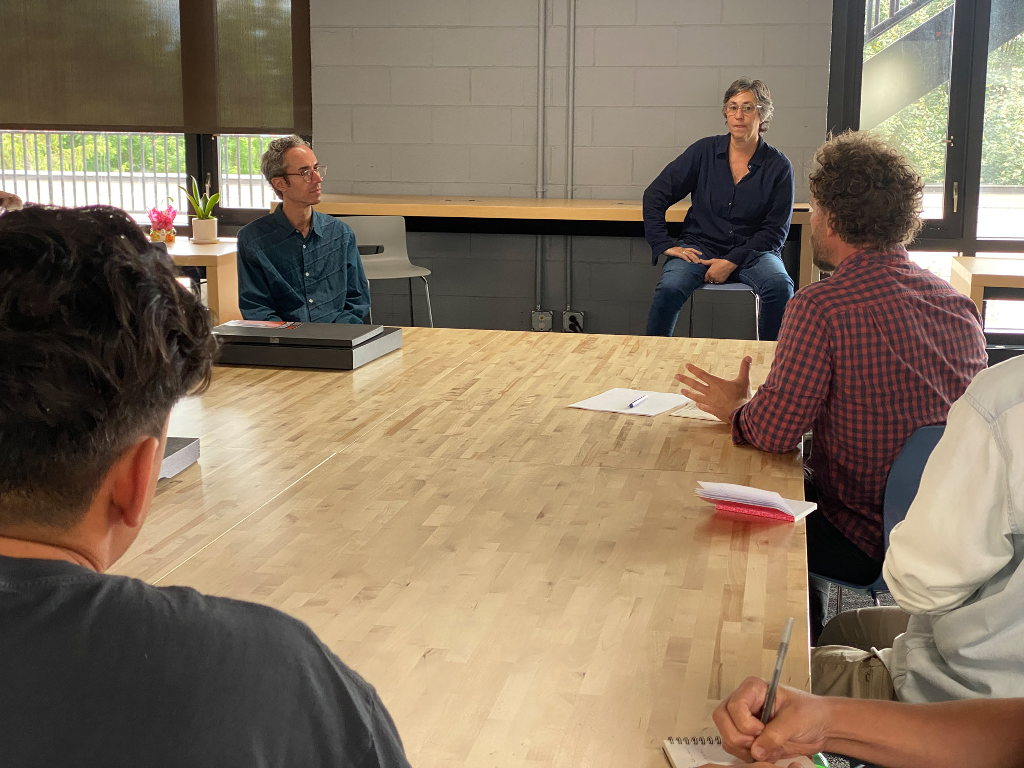 Sasha Wolf and Brendan Embser talk to a group of photographers.