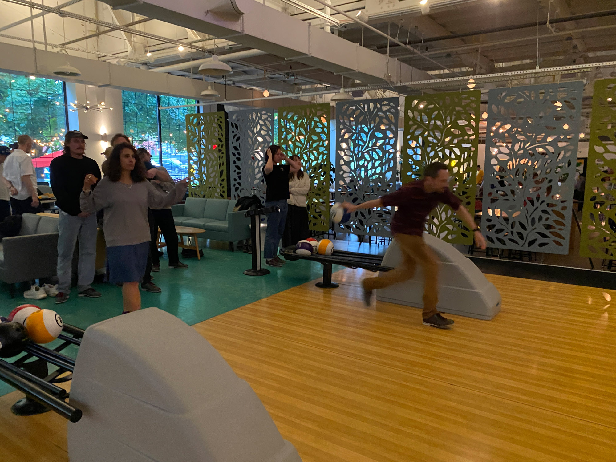 A group of people bowling.