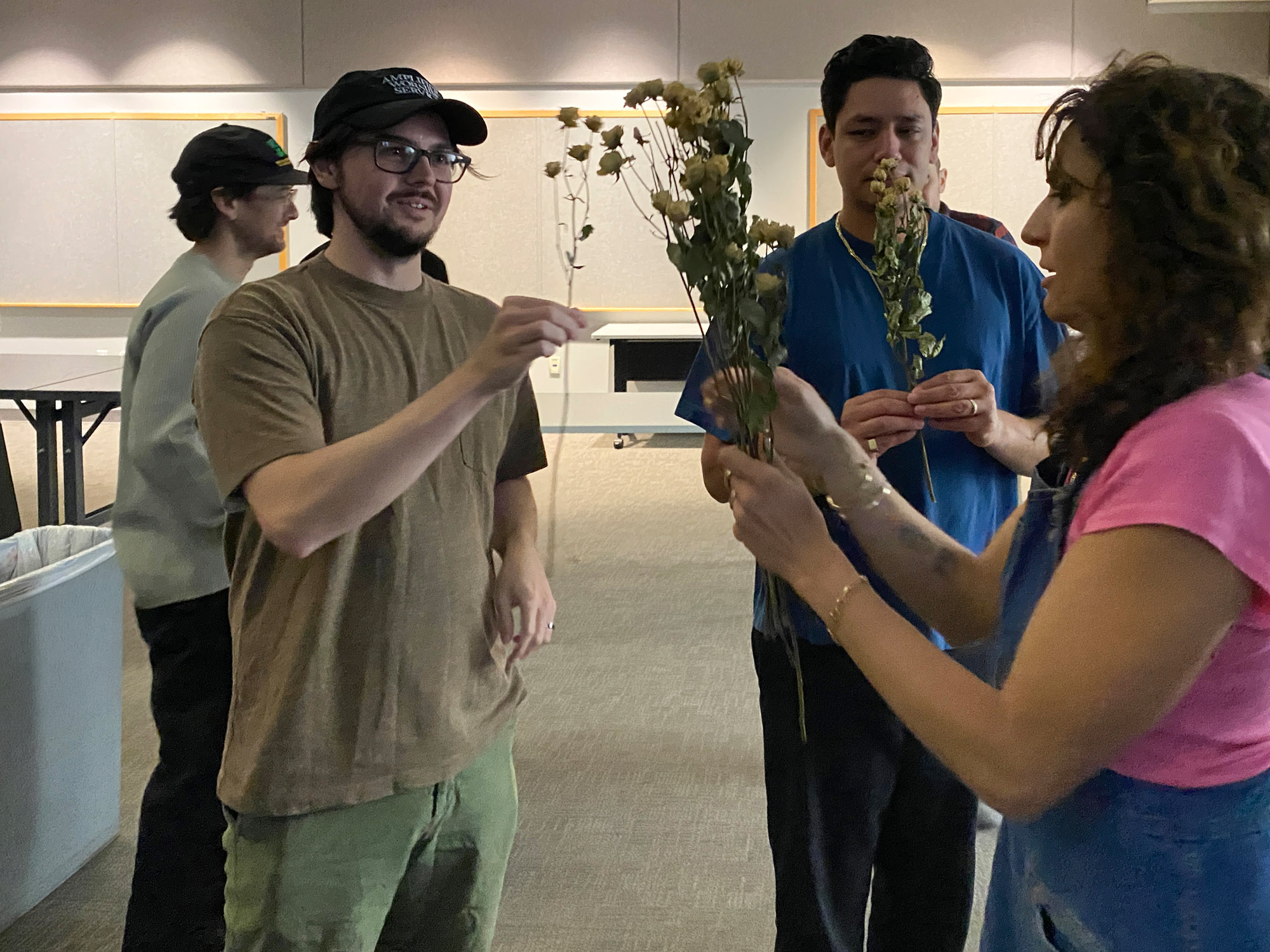 People look at a bouquet of flowers.