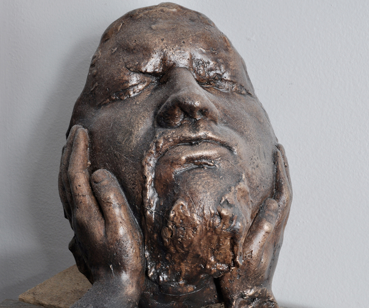 A bronze sculpture of a face.