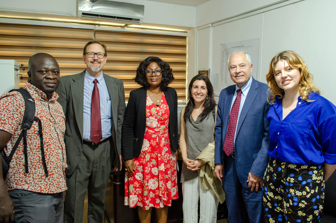 A group of people stand together and pose for a photo.