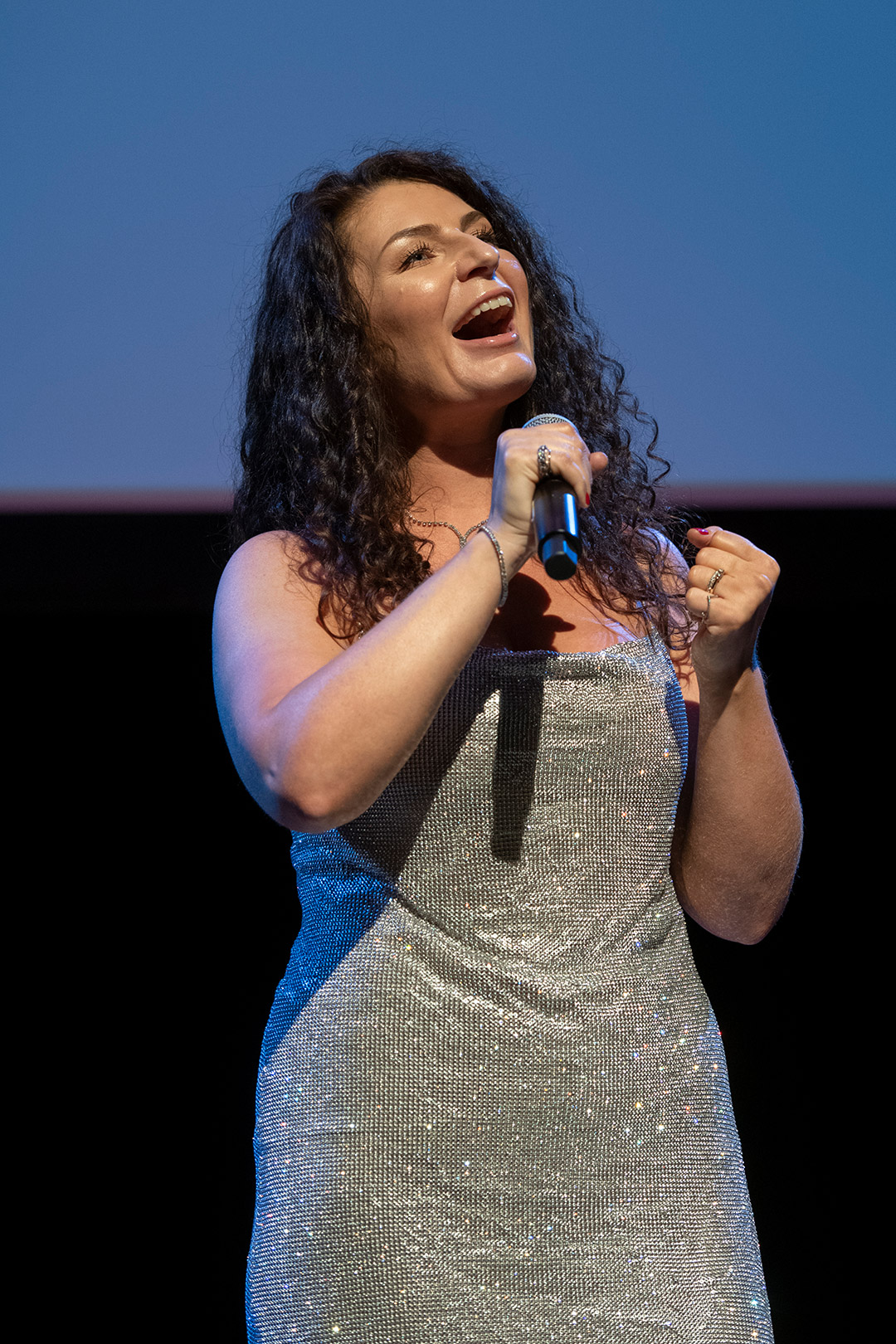 student singing into a microphone.