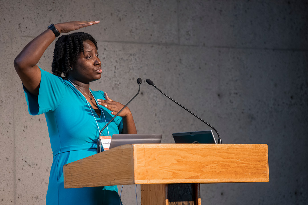 woman speaking at a podium.