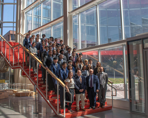Student cohort posing for photo on SHED staircase