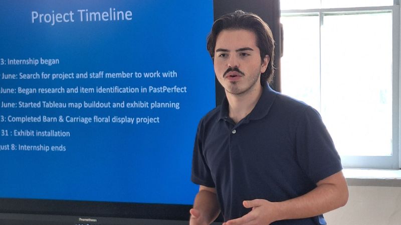 nathaniel giving a presentation about his project at the museum