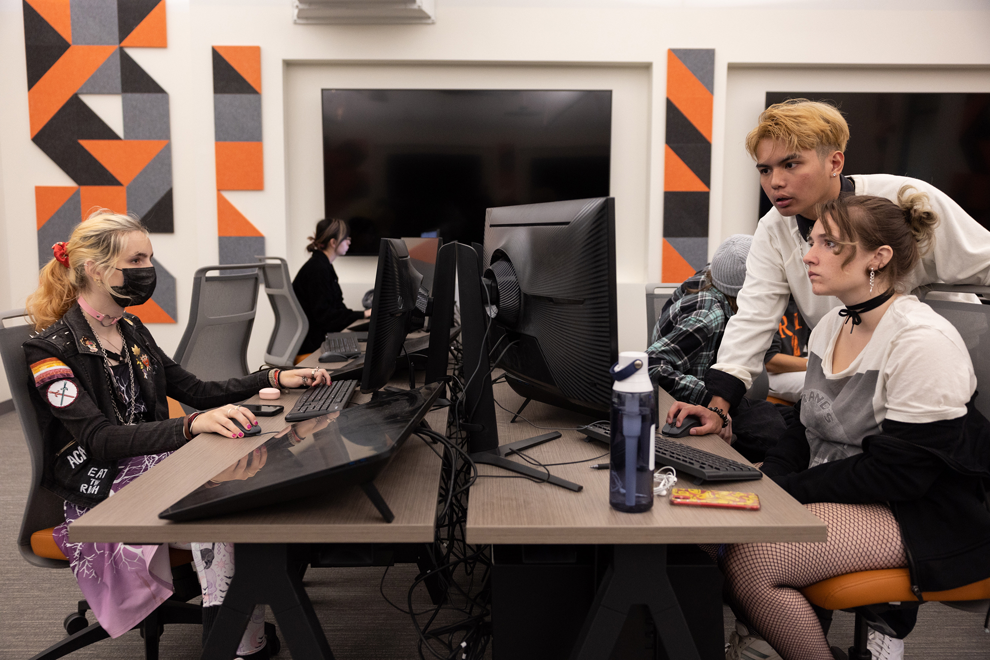 Students work together at computer stations.