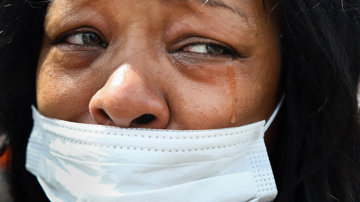 A close-up photo of a woman shedding tears.