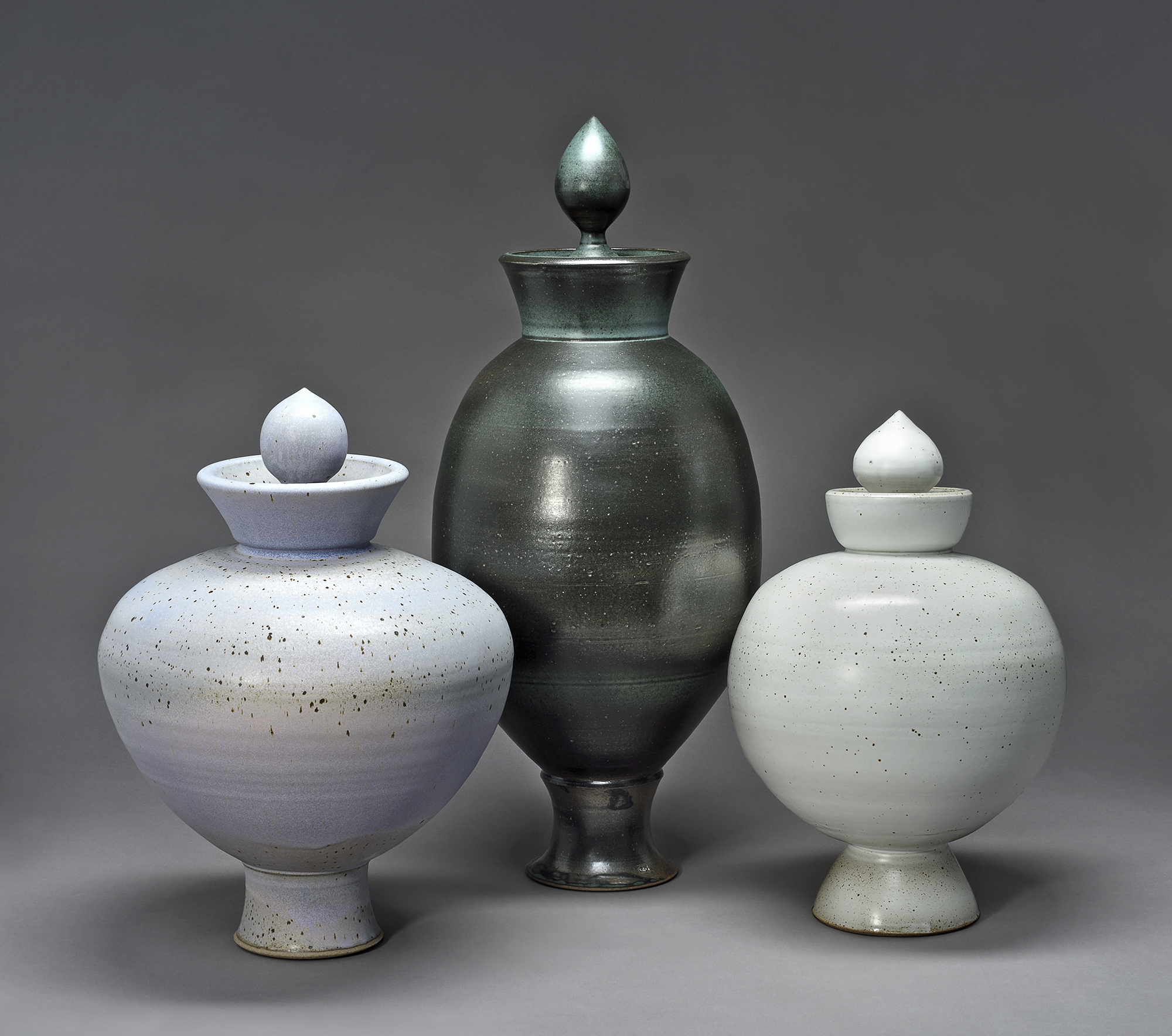 Three large ceramic vessels, side by side.