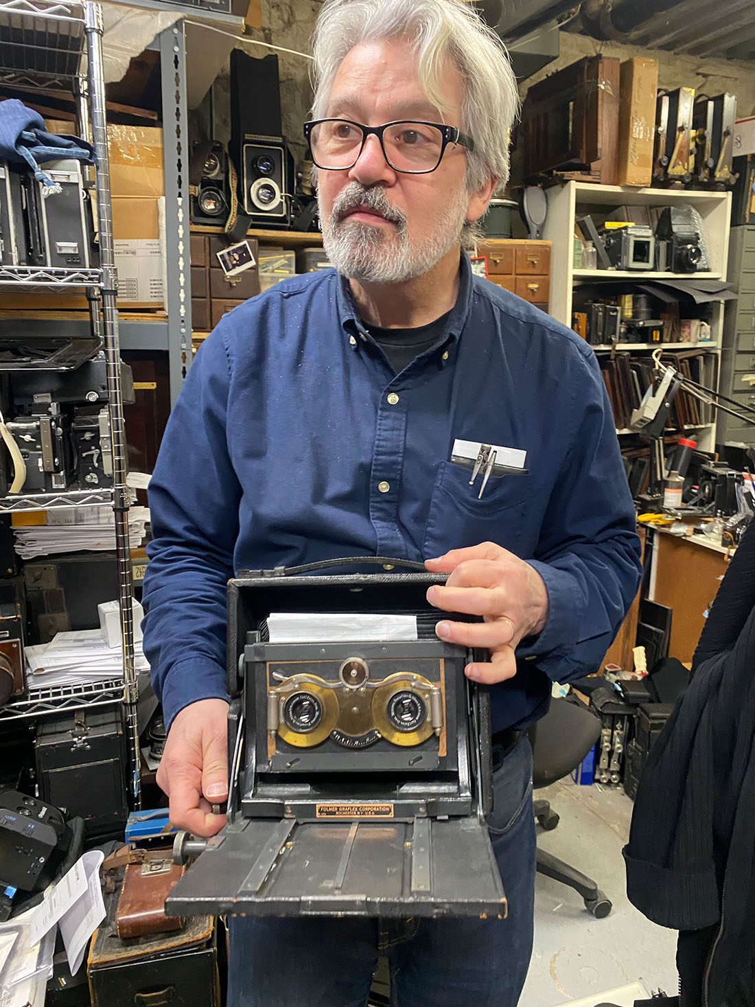 Geoffrey Berliner showing off his collection of historic cameras at Penumbra Foundation.