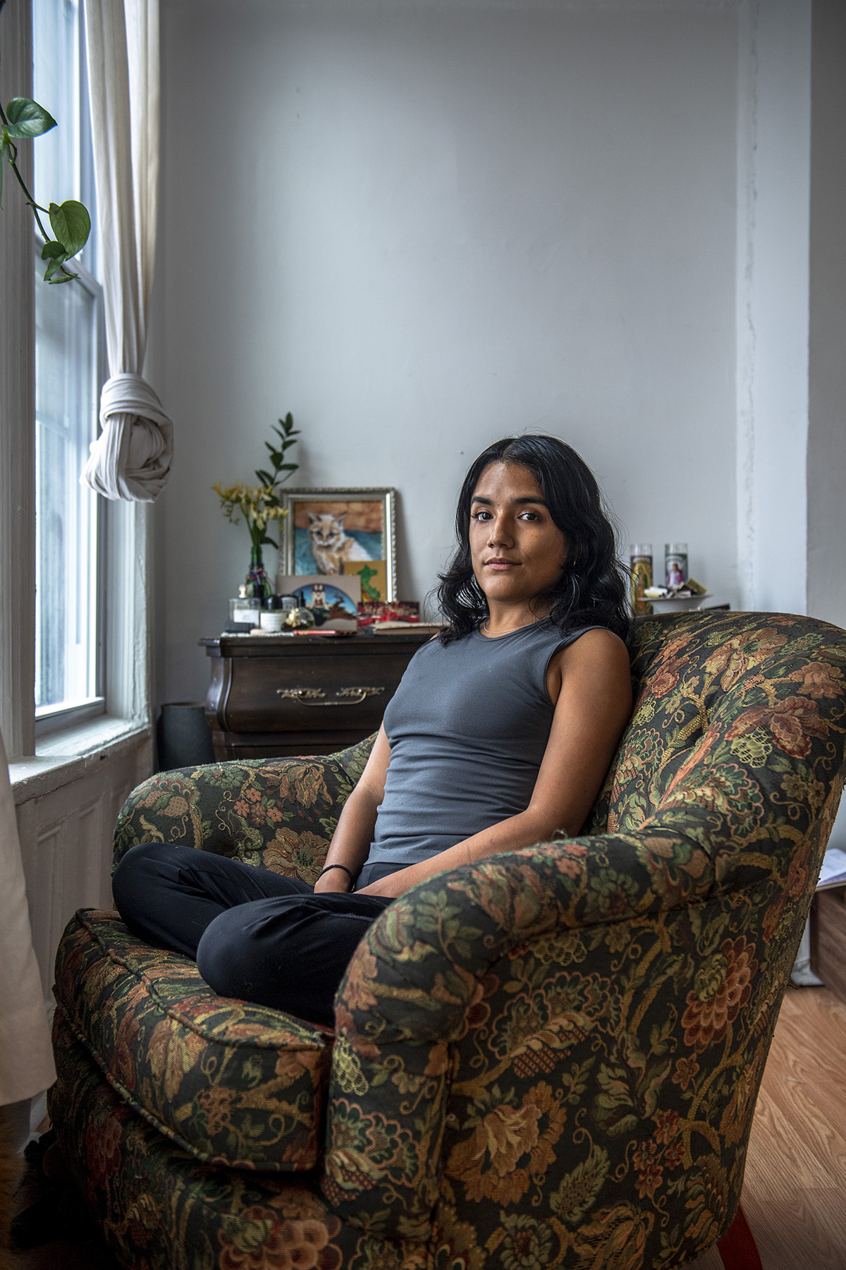 Belinda Stahl sits in a chair at her home in Brooklyn.