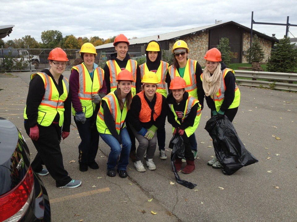 Group of women in contruction vests and hard hats pose