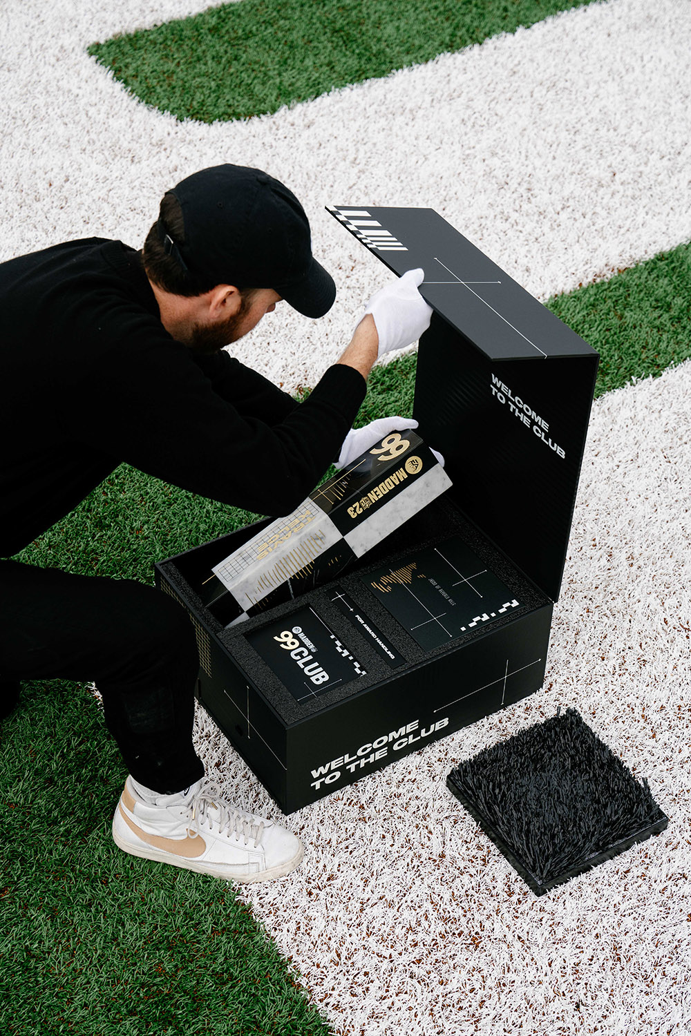 Brian Madden packs a box with a Madden NFL sculpture he made.