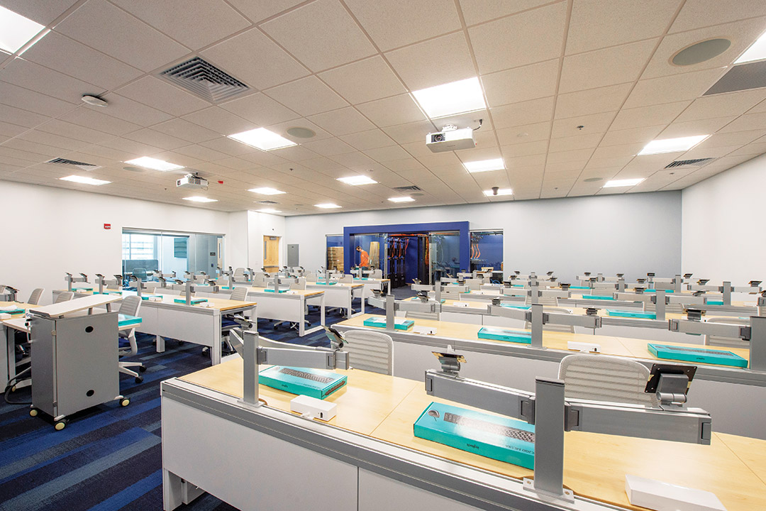 room with tables and computer stations.